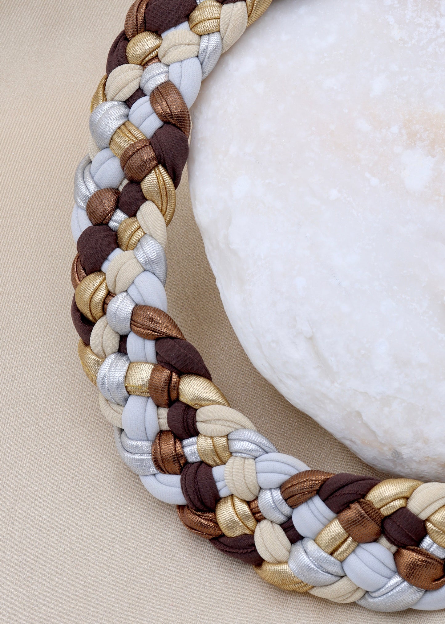 Braided necklace with mix of neutral and metallic colors perfect to elevate any elegant and luxurious outfit.